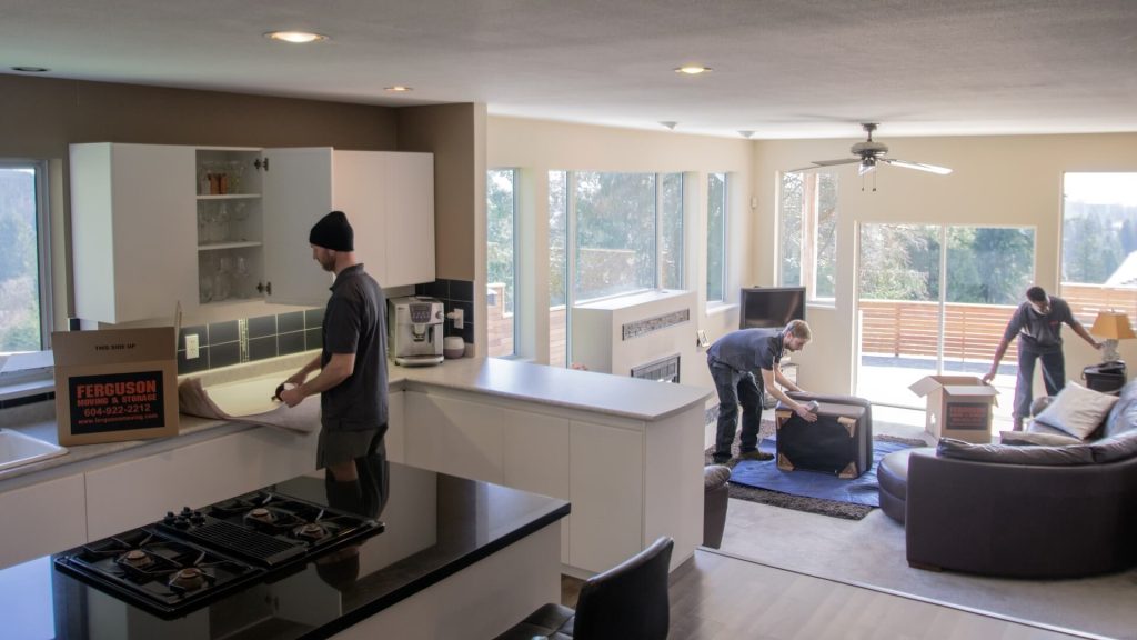 Toronto movers carefully packing up furniture during a residential move.