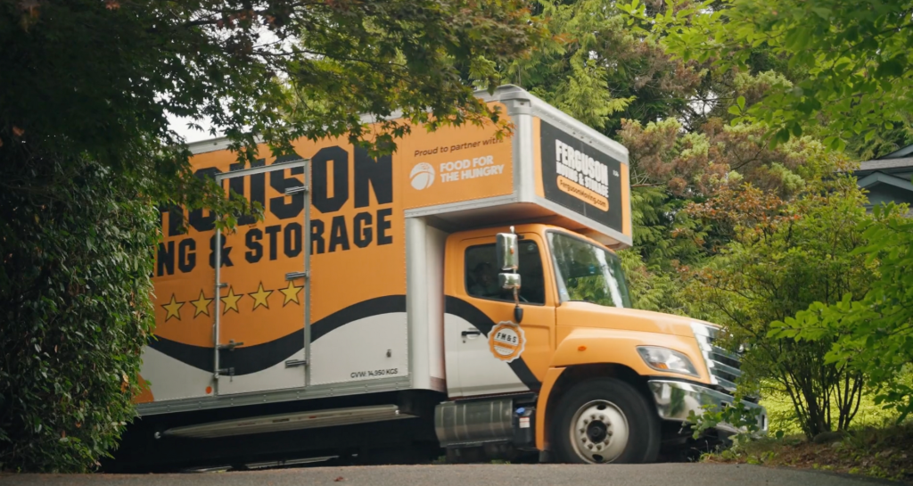 Ferguson Truck parked in front of green trees in a residential neighbourhood.