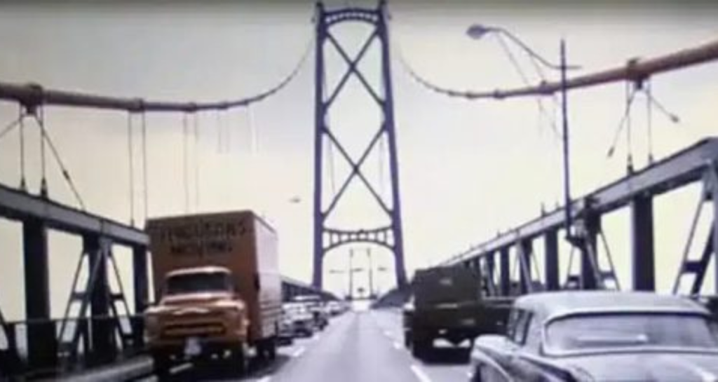 Vintage photo of a Ferguson moving truck driving across the Lions Gate bridge in the 1960's.