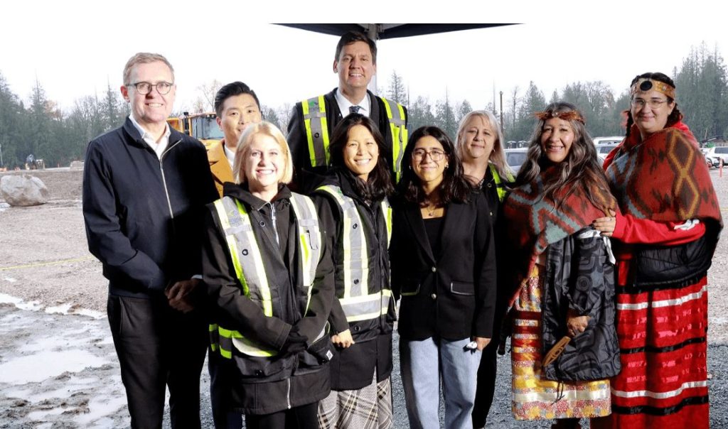 A group of Langley City Officials smile as they announce the construcion of some new schools