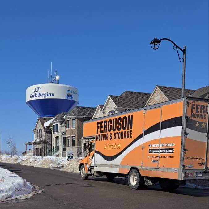 Ferguson moving truck driving by the York Region water tower in a residential street.
