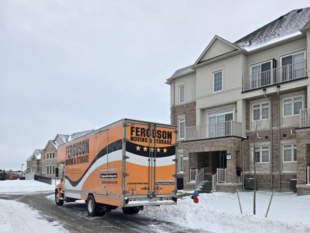 Toronto moving company with their truck parked beside a home.