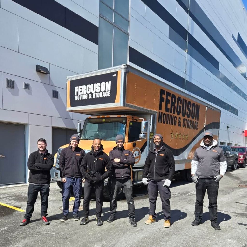 Ferguson's Toronto movers are posed in front of a moving truck for a photoshoot.