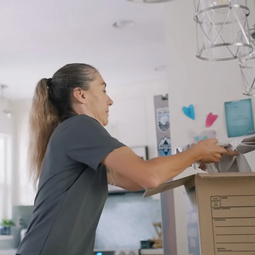 A woman packing up a home before a move