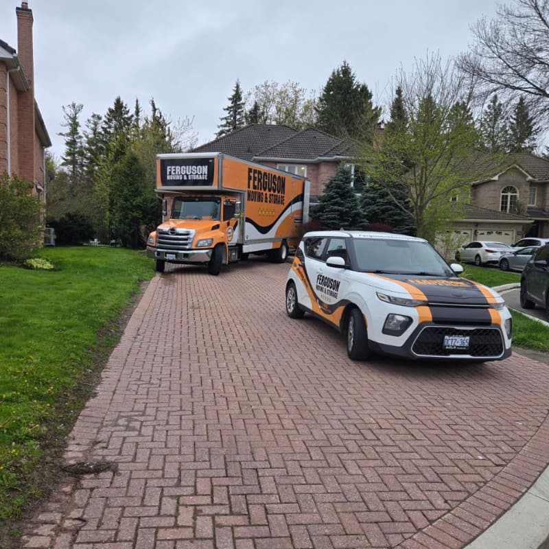 A Ferguson Truck and Car parked in front of a residential home in Aurora ON