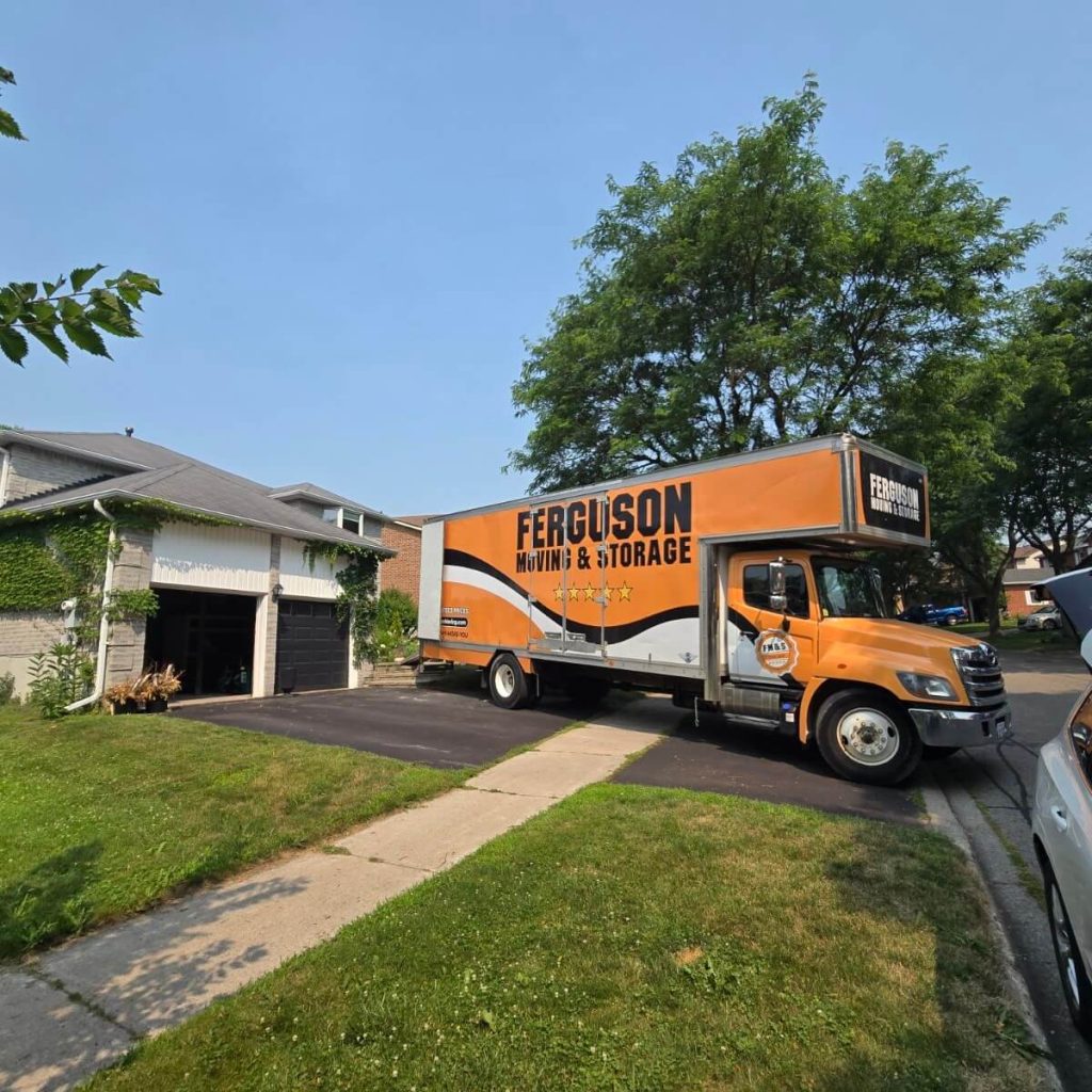 Close-up side profile of the Ferguson Moving & Storage truck in a sunny driveway