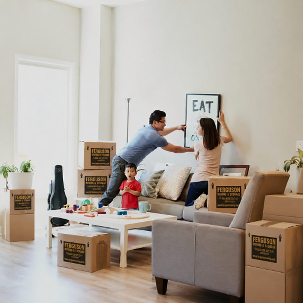 Family settling into a new home with Ferguson Moving & Storage moving boxes in the living room