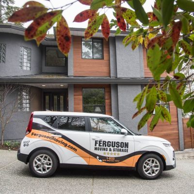 Ferguson vehicle parked outside a residential home during a local move.