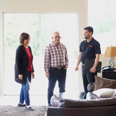 Ferguson local moving consultant discussing a pre-move quote with a couple.